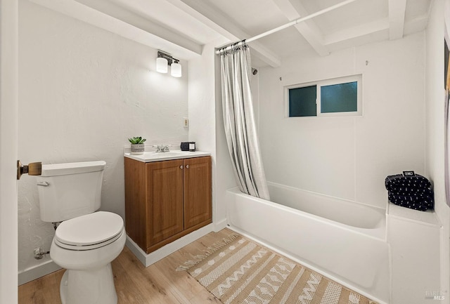 bathroom with vanity, baseboards, shower / bath combo, toilet, and wood finished floors