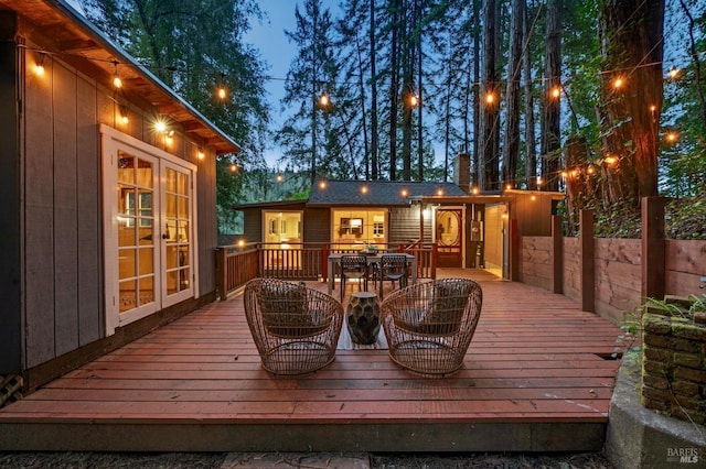wooden terrace with outdoor dining area
