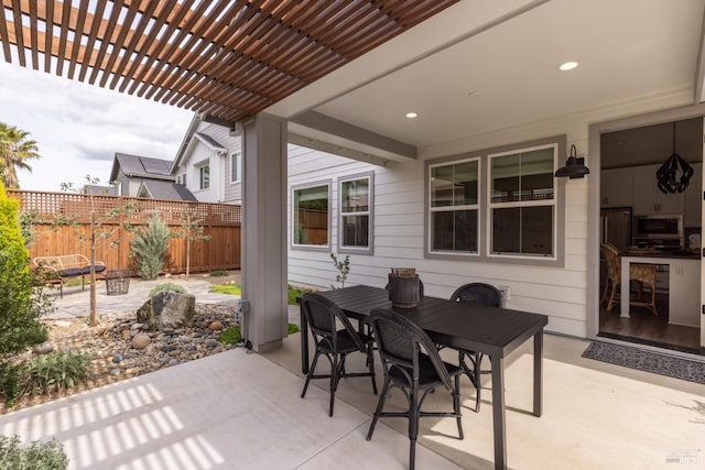 view of patio with a pergola, outdoor dining area, and fence