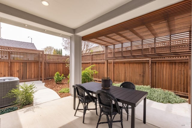 view of patio with central air condition unit, outdoor dining space, and a fenced backyard