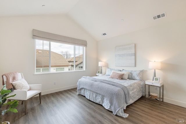 bedroom featuring visible vents, wood finished floors, and lofted ceiling