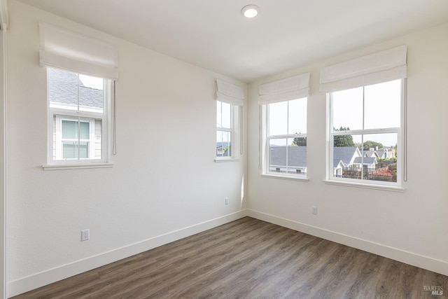 unfurnished room featuring baseboards and wood finished floors