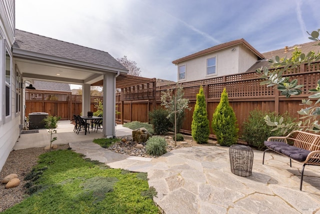 view of patio / terrace with central air condition unit and a fenced backyard