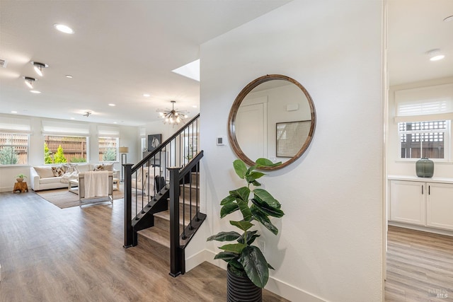 stairs with recessed lighting, baseboards, and wood finished floors