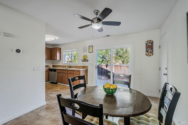 dining room featuring visible vents, ceiling fan, baseboards, and light tile patterned floors