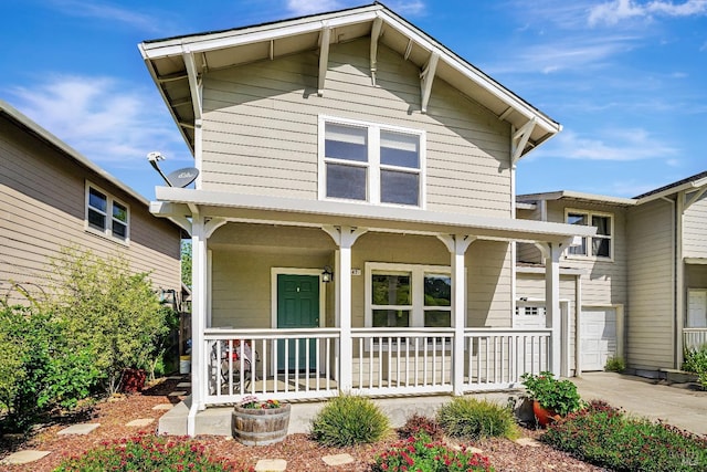 view of front of property featuring a porch and concrete driveway