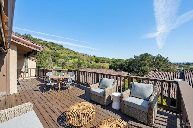 wooden terrace with outdoor lounge area and outdoor dining space