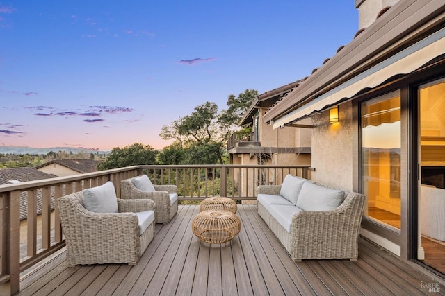 deck at dusk featuring outdoor lounge area