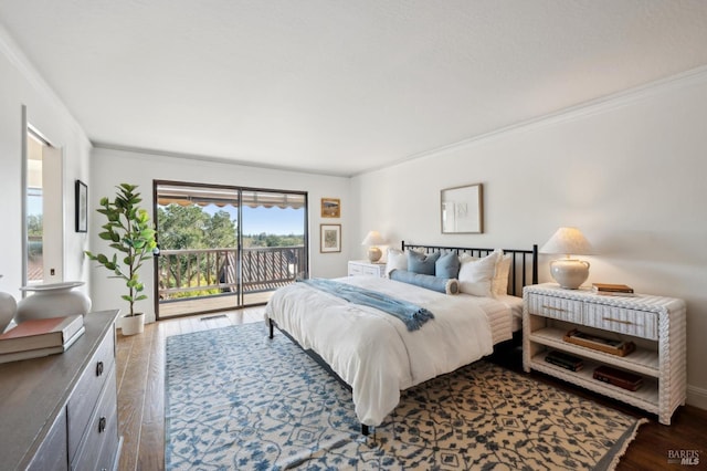 bedroom featuring access to outside, crown molding, and wood finished floors
