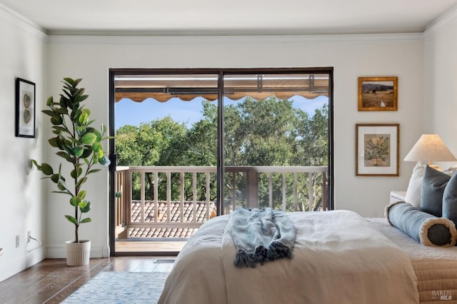bedroom with crown molding, multiple windows, access to outside, and wood finished floors