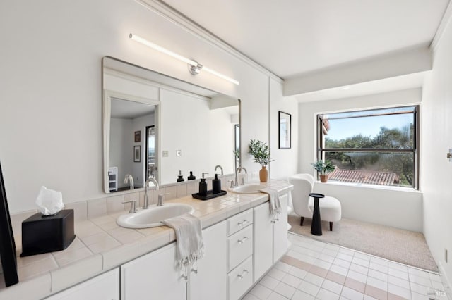 full bath featuring tile patterned floors, double vanity, and a sink