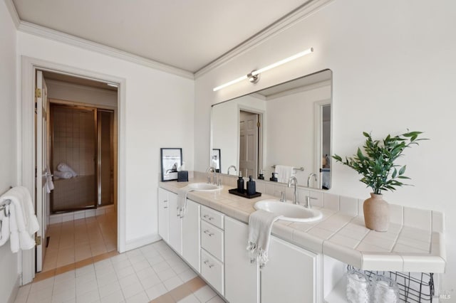 full bath featuring tile patterned floors, double vanity, a sink, and ornamental molding