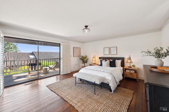 bedroom featuring visible vents, baseboards, ornamental molding, wood-type flooring, and access to outside