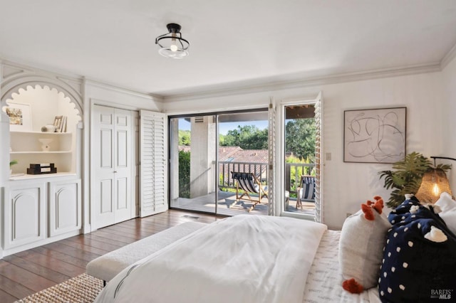 bedroom with ornamental molding, access to outside, and hardwood / wood-style floors