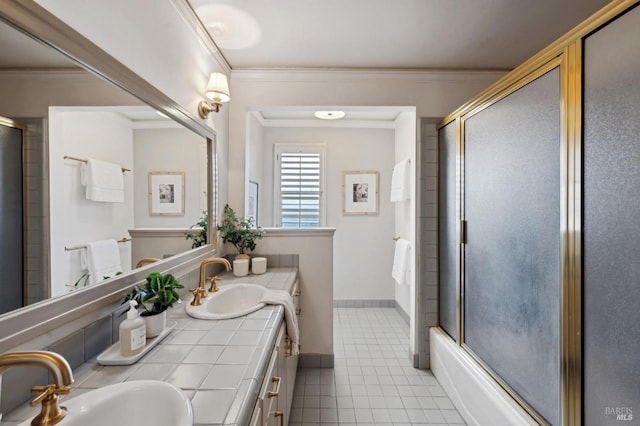 full bath featuring crown molding, a sink, and a shower with door