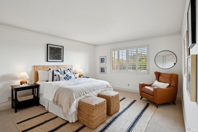 bedroom featuring crown molding, baseboards, and light carpet