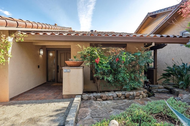 entrance to property with stucco siding