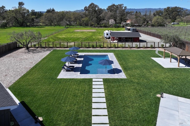 view of home's community featuring a swimming pool, a patio area, and a view of rural / pastoral area