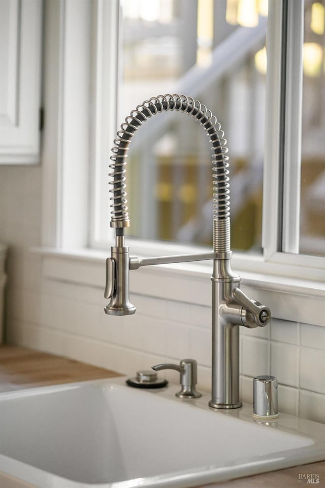 19 Savannah Ave, San Anselmo, CA 94960 - room details with a sink, backsplash, light countertops, and white cabinetry