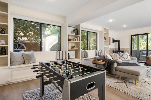 19 Savannah Ave, San Anselmo, CA 94960 - playroom with light wood-style floors, a wood stove, built in shelves, and recessed lighting