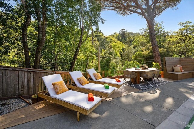 19 Savannah Ave, San Anselmo, CA 94960 - view of patio featuring a wooded view, outdoor dining space, fence, and a deck