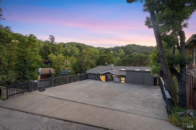 19 Savannah Ave, San Anselmo, CA 94960 - view of patio with driveway, a forest view, a garage, and fence