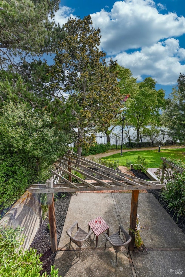 view of property's community with a yard and fence