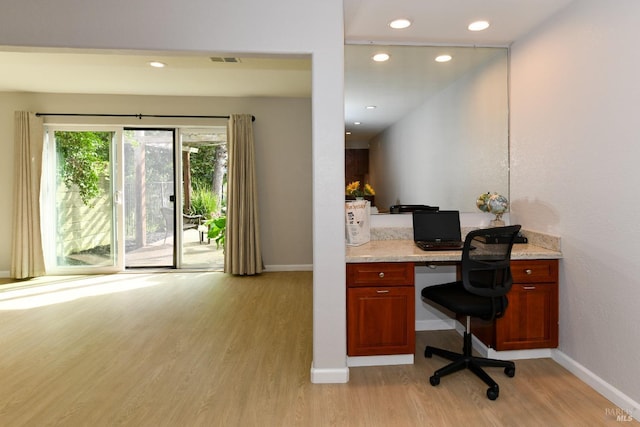 office with baseboards, recessed lighting, built in study area, light wood-style flooring, and visible vents