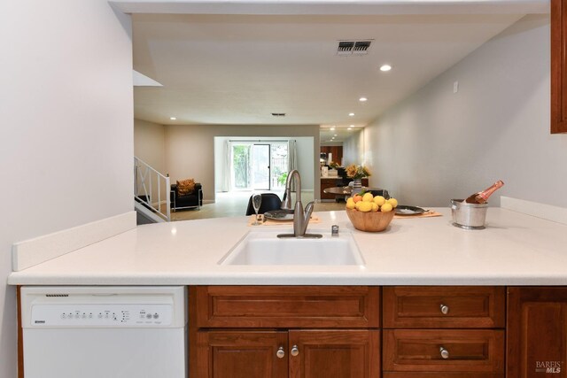 kitchen with visible vents, white dishwasher, a sink, open floor plan, and recessed lighting