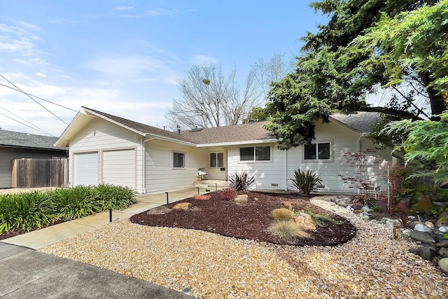 single story home with an attached garage and fence