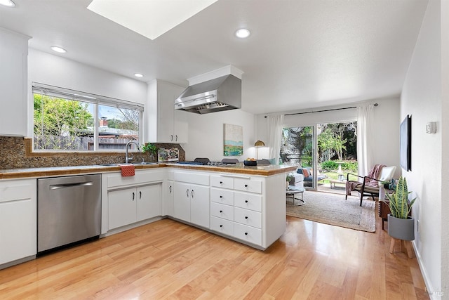 kitchen with wall chimney exhaust hood, dishwasher, a sink, open floor plan, and gas stovetop