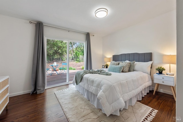 bedroom with access to exterior, wood finished floors, and baseboards