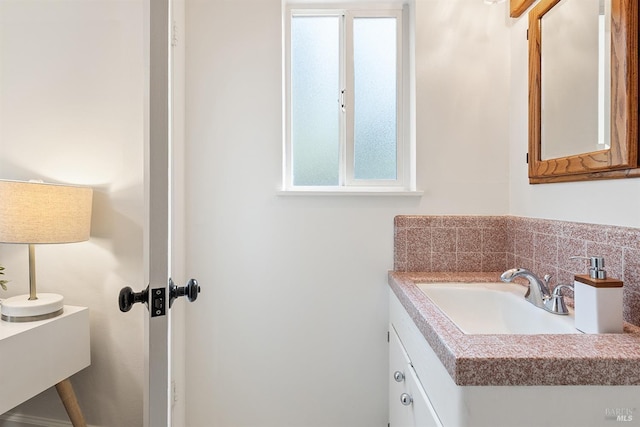 bathroom with vanity and decorative backsplash