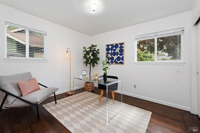 sitting room with baseboards and wood finished floors