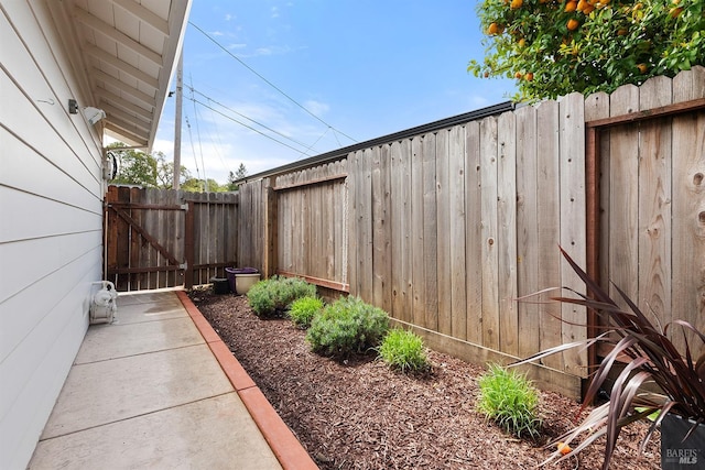 view of yard with fence and a gate