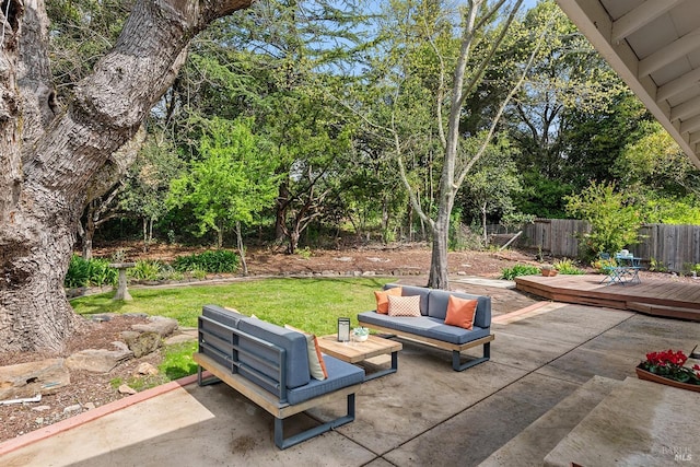 view of patio / terrace with an outdoor living space, a wooden deck, and fence