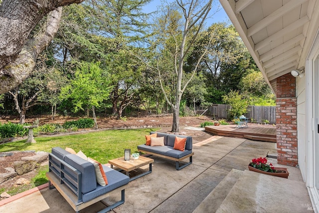 view of patio with fence, a deck, and an outdoor hangout area