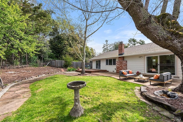 view of yard with an outdoor living space with a fire pit, fence, and a wooden deck