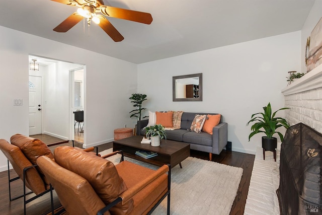 living room with wood finished floors, baseboards, and a ceiling fan