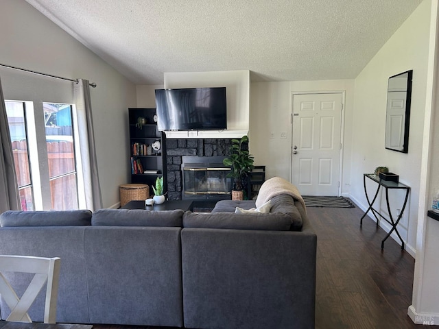 336 Hamilton Dr, Fairfield, CA 94533 - living room featuring lofted ceiling, dark wood finished floors, a textured ceiling, baseboards, and a fireplace