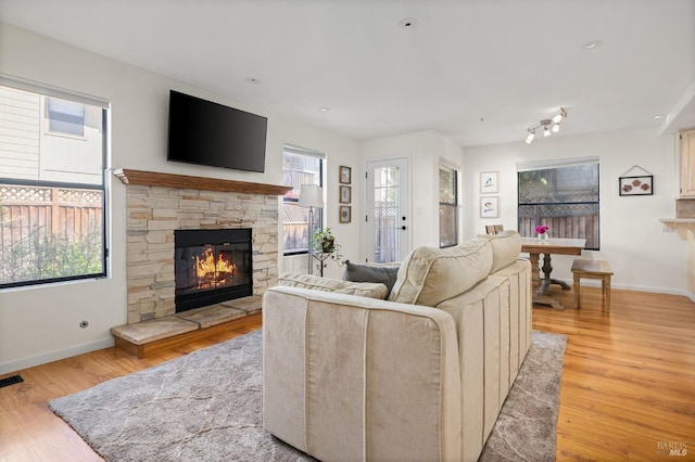3222 Villa Ln, Napa, CA 94558 - living room featuring plenty of natural light, light wood-style floors, and a stone fireplace