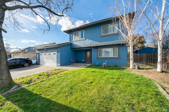 traditional-style home featuring stucco siding, a front yard, fence, an attached garage, and concrete driveway