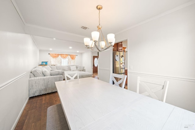 dining room with visible vents, an inviting chandelier, crown molding, and dark wood finished floors