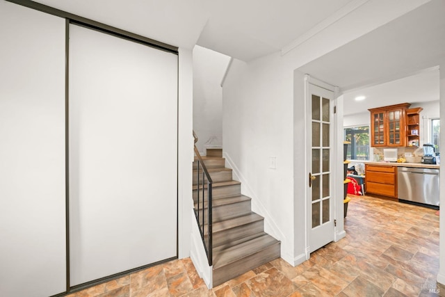 staircase with baseboards and stone finish flooring