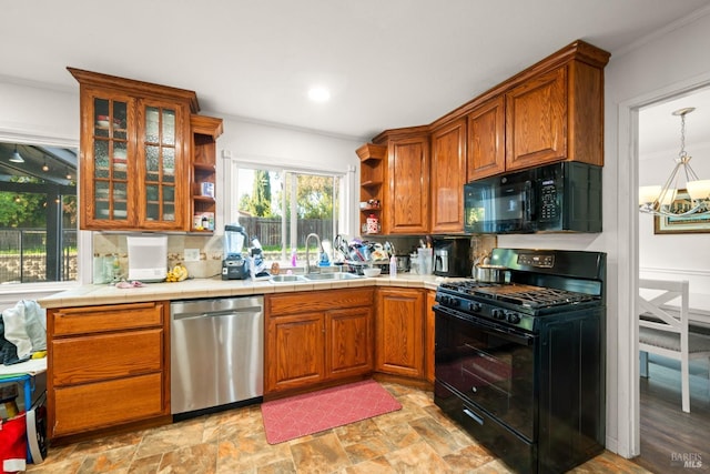 kitchen with tasteful backsplash, open shelves, a sink, a chandelier, and black appliances