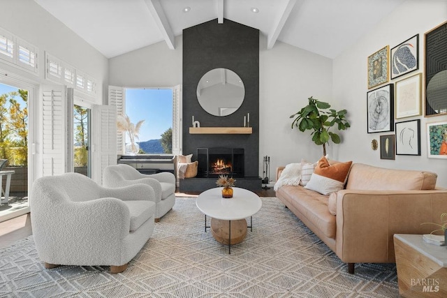 living room featuring a large fireplace, beamed ceiling, and high vaulted ceiling