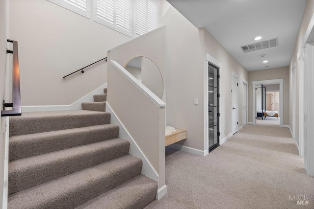 stairs with recessed lighting, carpet flooring, visible vents, and baseboards