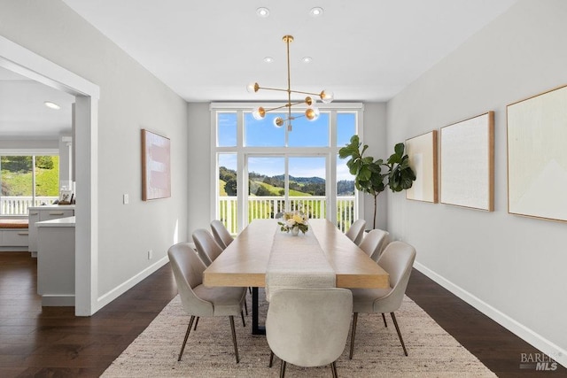 dining room with a chandelier, baseboards, dark wood finished floors, and recessed lighting