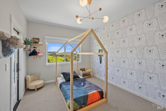 bedroom with baseboards, an inviting chandelier, and carpet floors