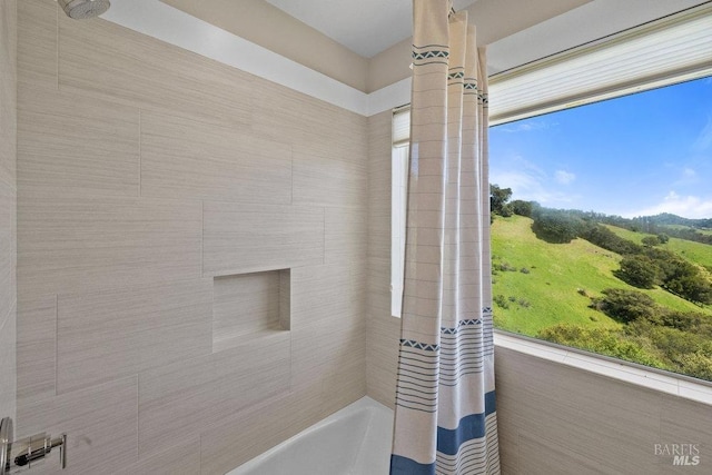 bathroom with shower / bath combination with curtain